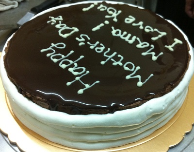 Chocolate Mousse Cake With Cream On The Sides And Words On The Top